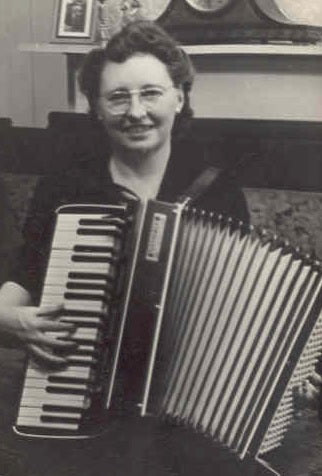 Owner, Gladys Newell playing accordion